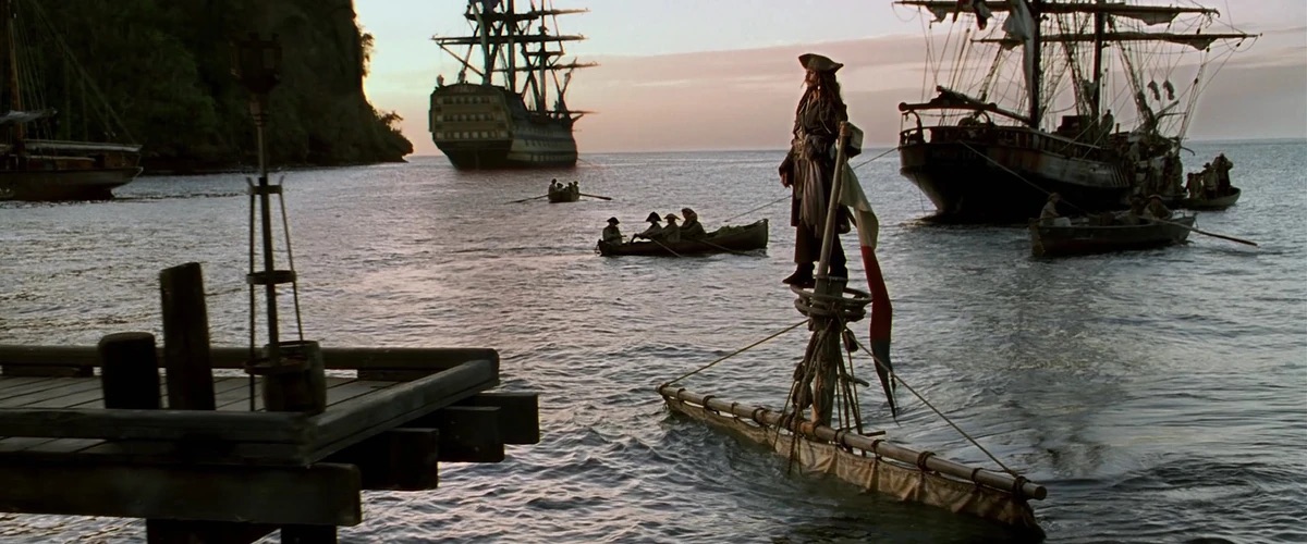 Movie screenshot of Captain Jack Sparrow walking off the top of the main mast before the ship sinks.